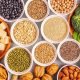 array of vegan protein sources, including legumes, nuts, grains, vegetables, and tofu