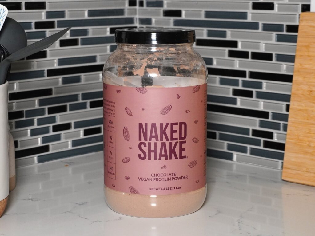 Tub of Naked Nutrition vegan protein powder